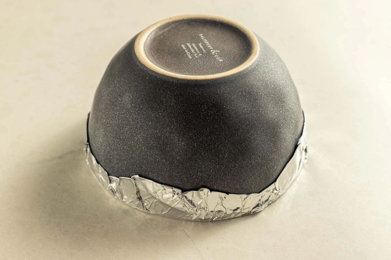 Upside down bowl with foil wrapped beneath 