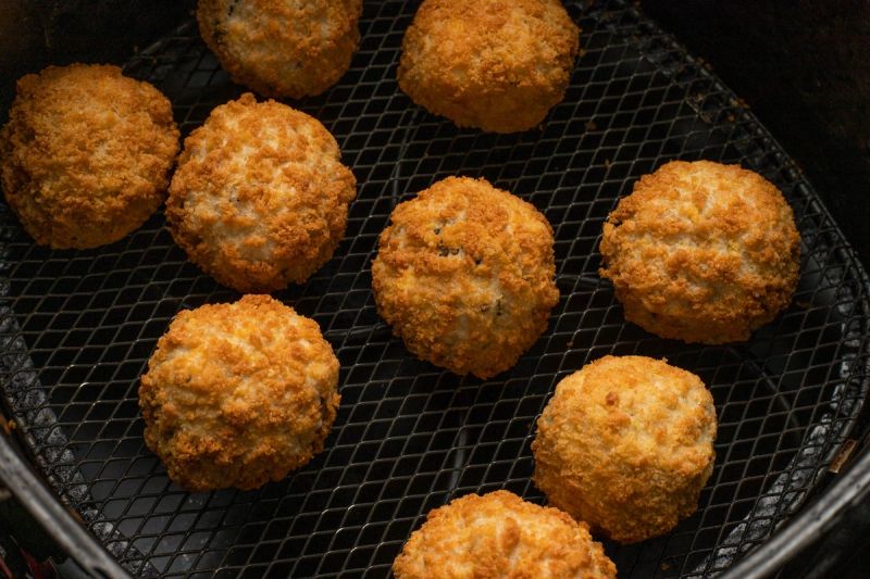 Frozen arancini balls in air fryer basket