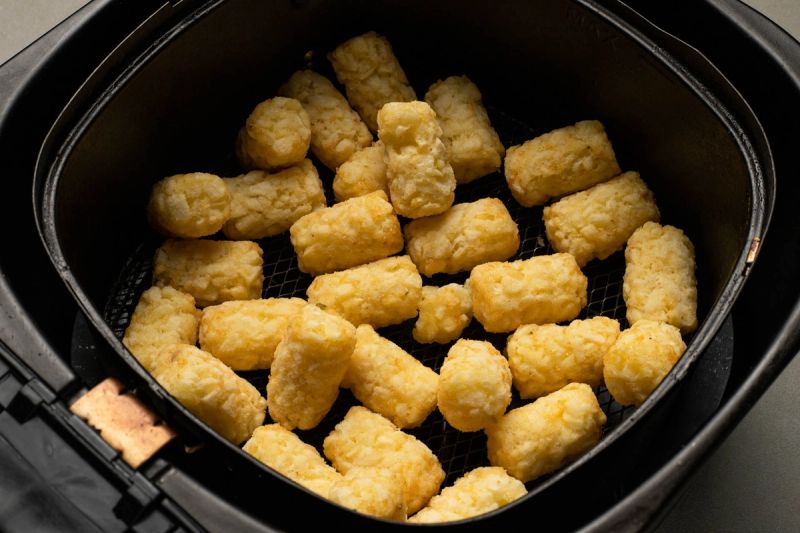 Frozen potato gems in air fryer basket Frozen potato gems in air fryer basket