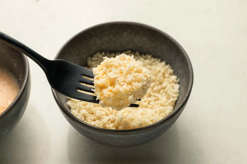 Dredging goats cheese in breadcrumbs
