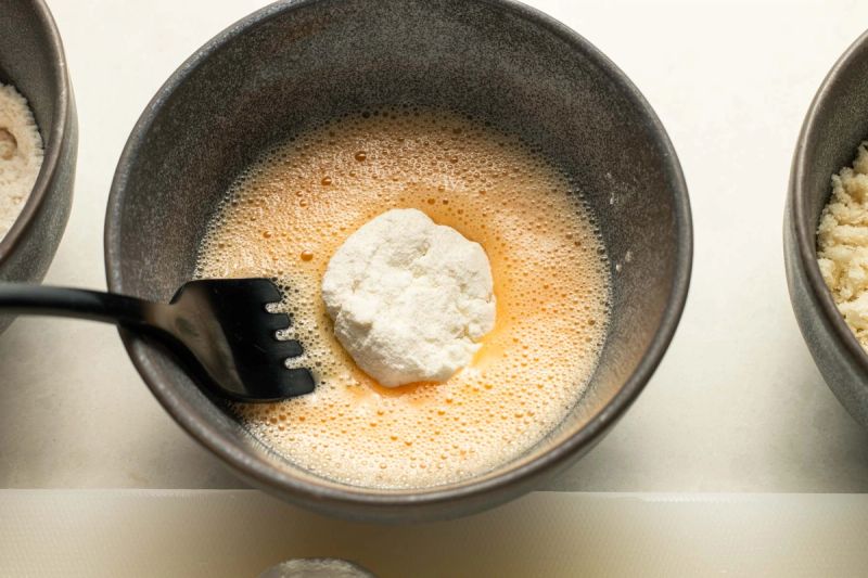 Dipping goats cheese in egg Dipping goats cheese in egg