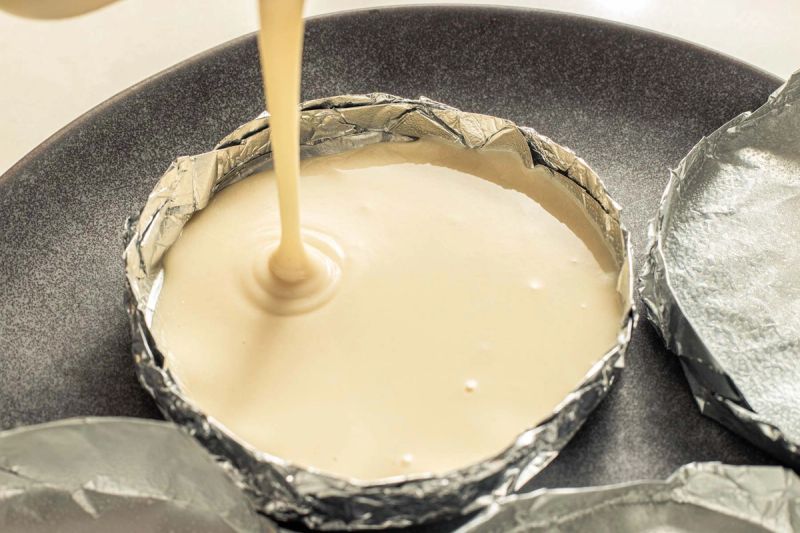 Pouring pancake batter into foil tray