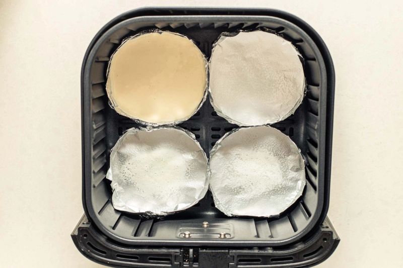 Foil trays in air fryer basket Foil trays in air fryer basket