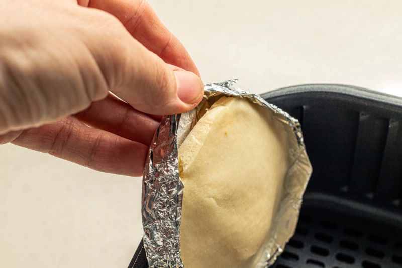 Peeling foil tray from pancake Peeling foil tray from pancake