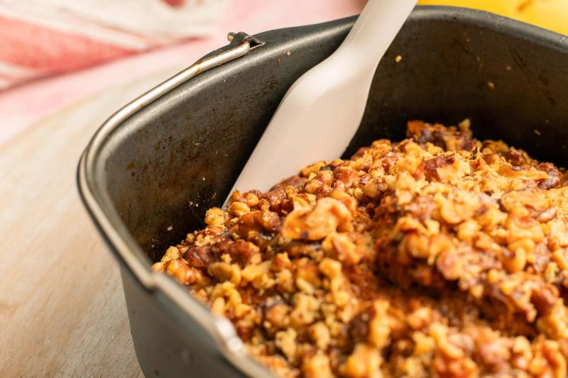 Prying edge of banana bread with a spatula