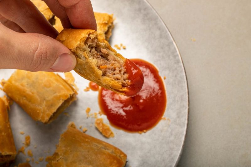 Air fried sausage roll dipped in tomato sauce Air fried sausage roll dipped in tomato sauce