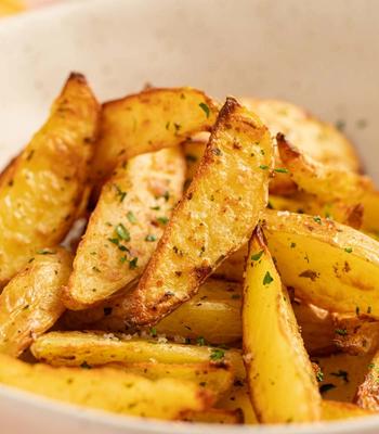 Air fried potato wedges in a bowl