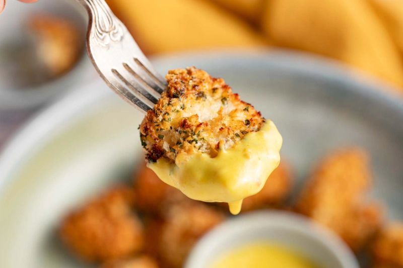 Chicken bite dipped in mustard sauce