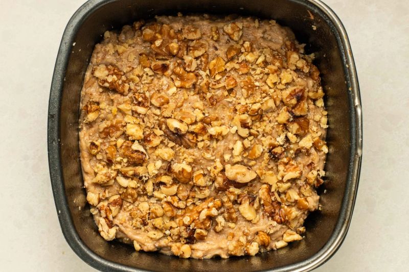 Raw banana bread with walnuts in a baking tin Raw banana bread with walnuts in a baking tin