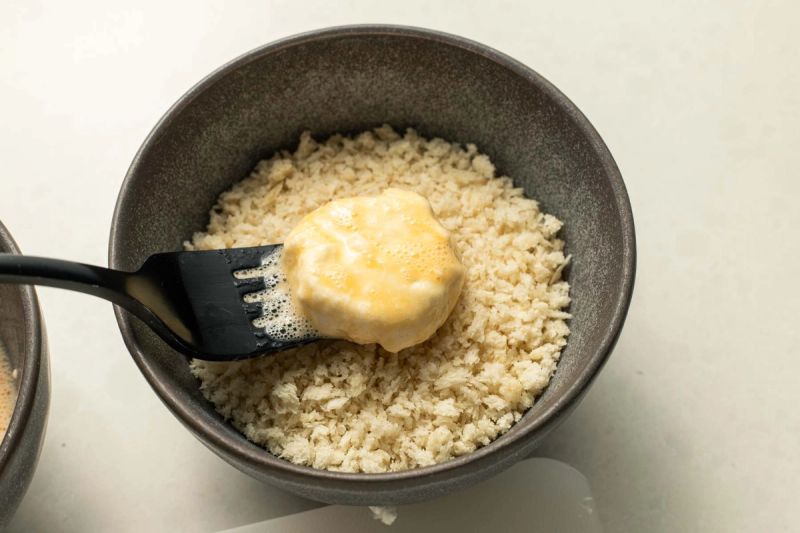 Dredging goats cheese in breadcrumbs Dredging goats cheese in breadcrumbs