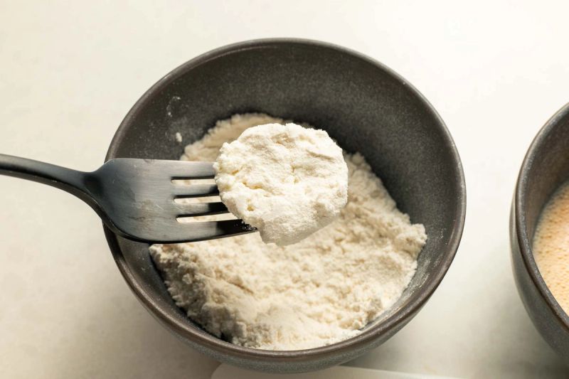 Dredging goats cheese in flour