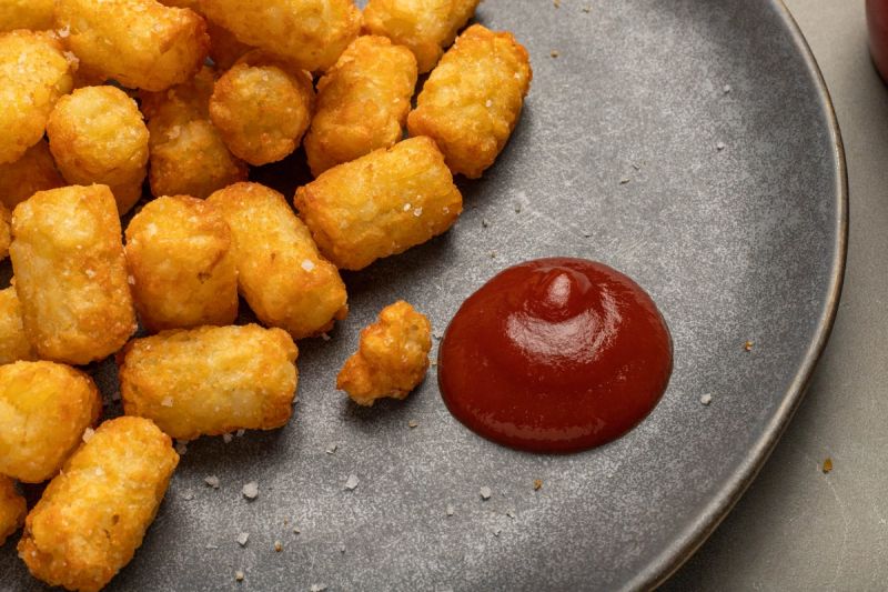 Air fried potato gems with tomato sauce on a plate