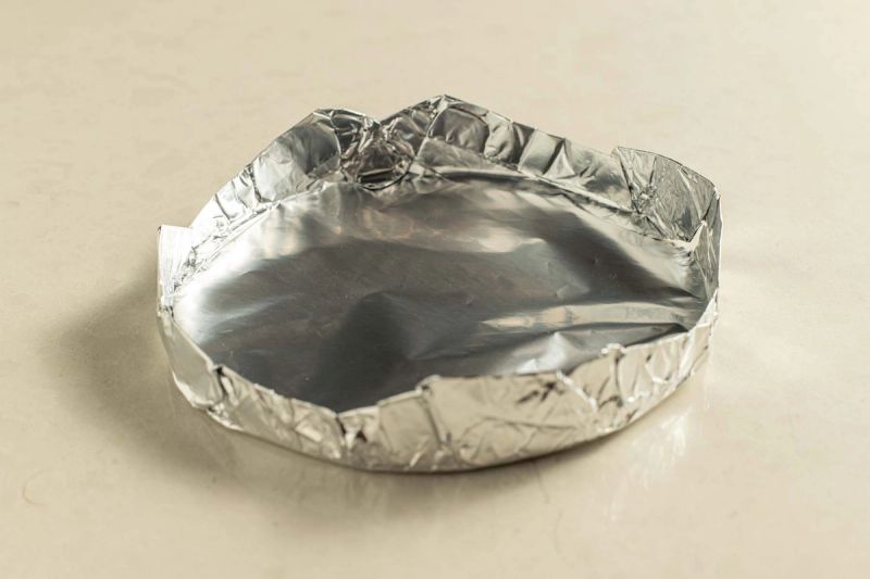 Aluminum foil shaped into a pancake mould