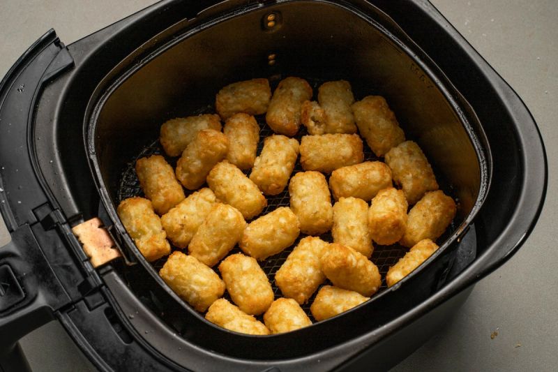 Semi cooked potato gems in air fryer basket