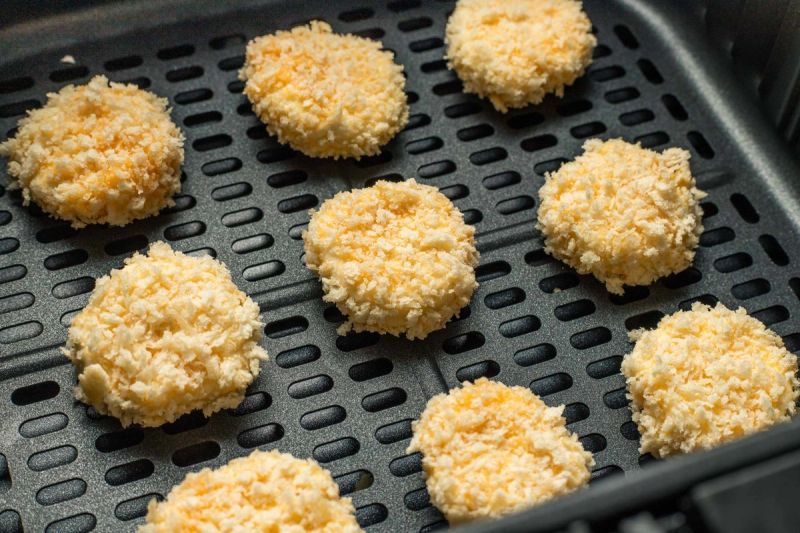 Breaded goats cheese in air fryer basket Breaded goats cheese in air fryer basket