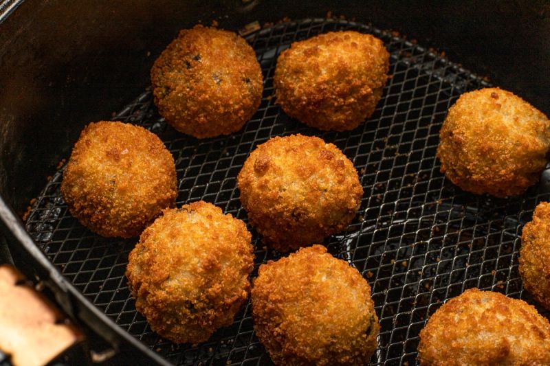 Air fried arancini in air fryer basket