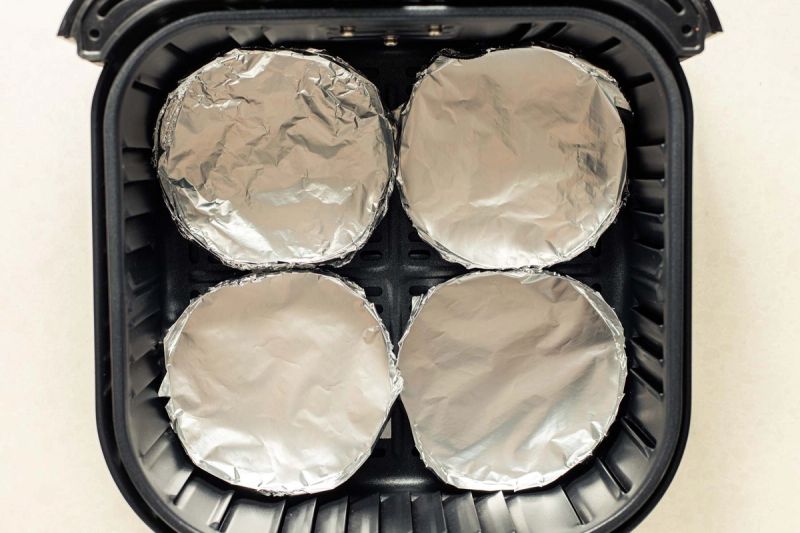 4 aluminum foil moulds in an air fryer basket 4 aluminum foil moulds in an air fryer basket