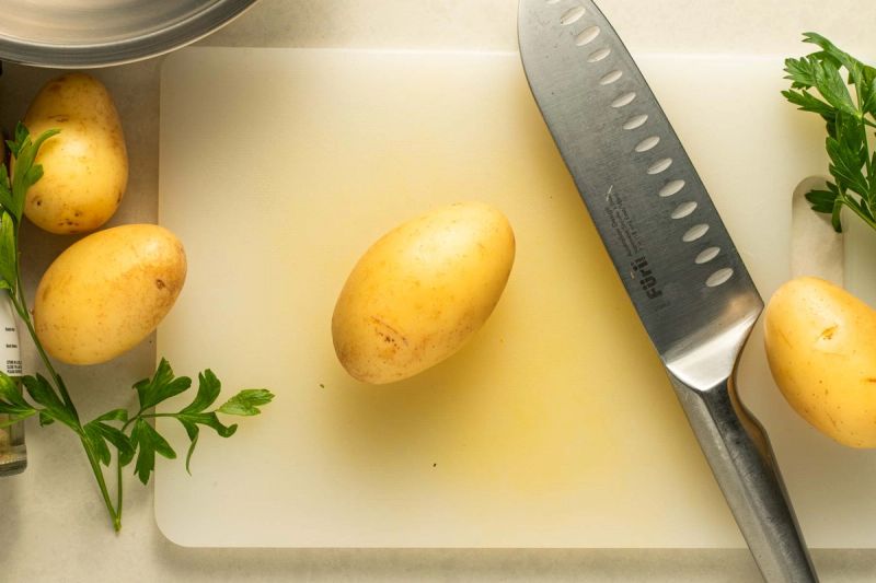 Potato on chopping board Potato on chopping board