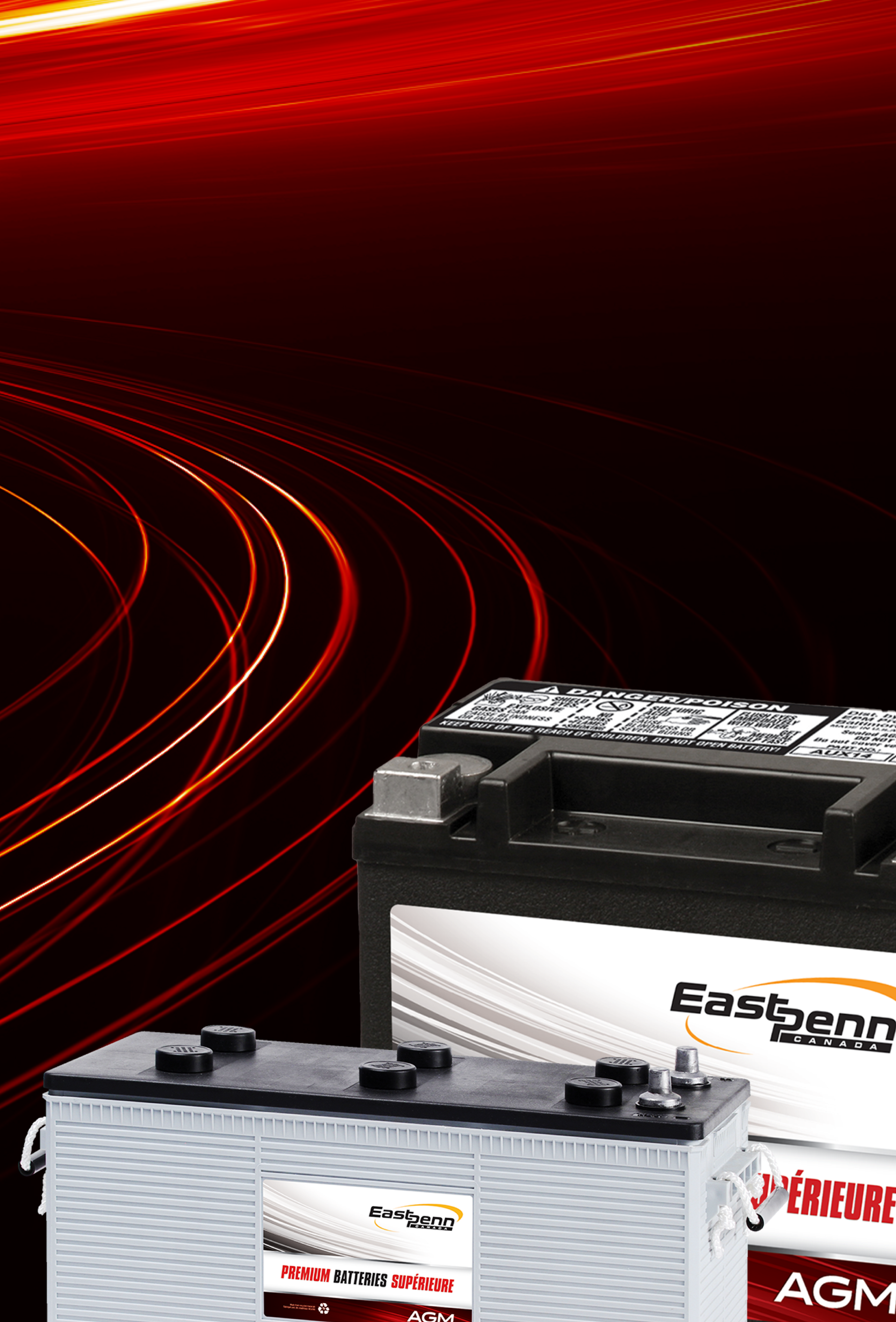 Picture of two East Penn brand car batteries on a black background with red and orange light flares