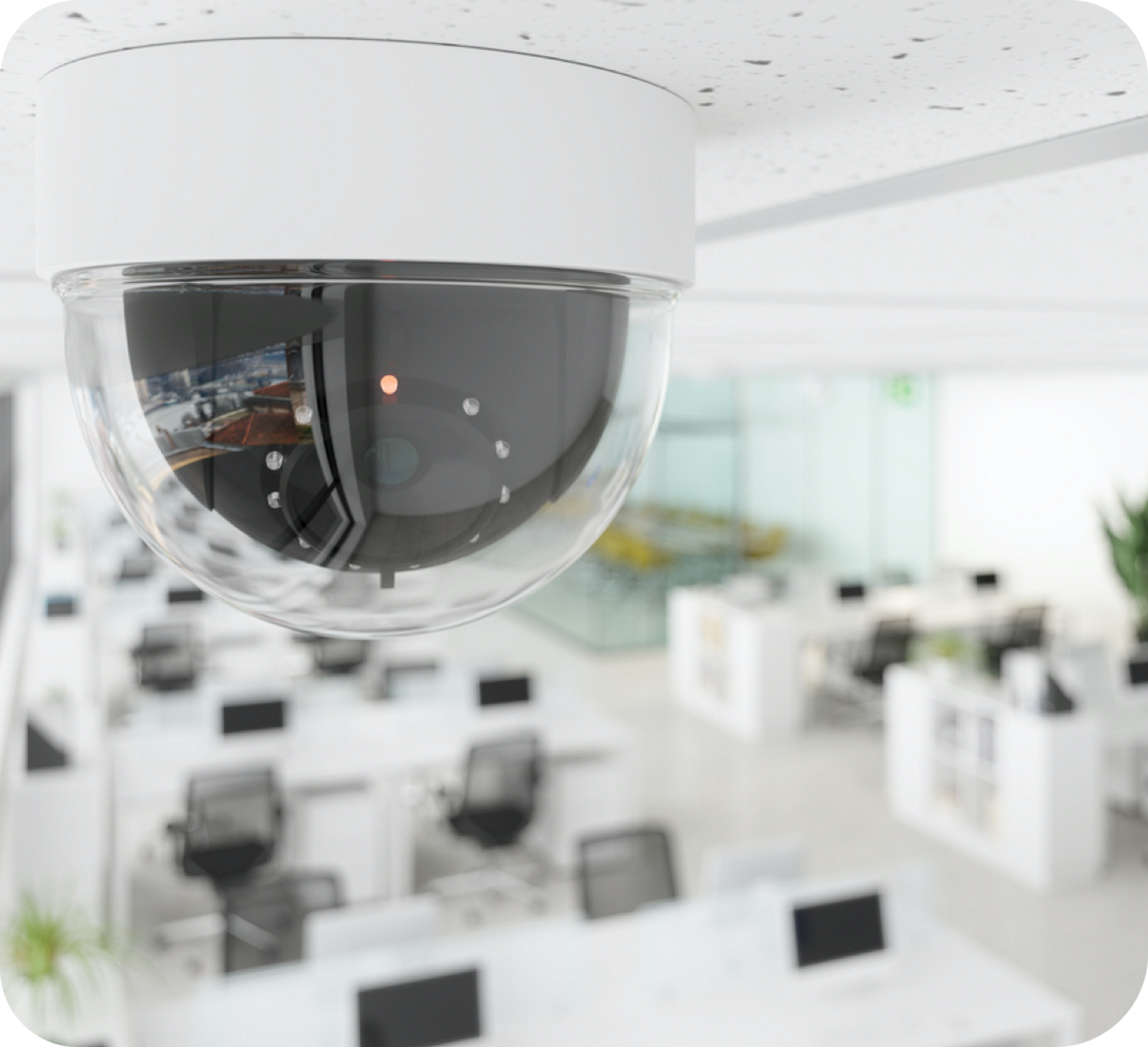 Picture of a security camera on the roof above office desks