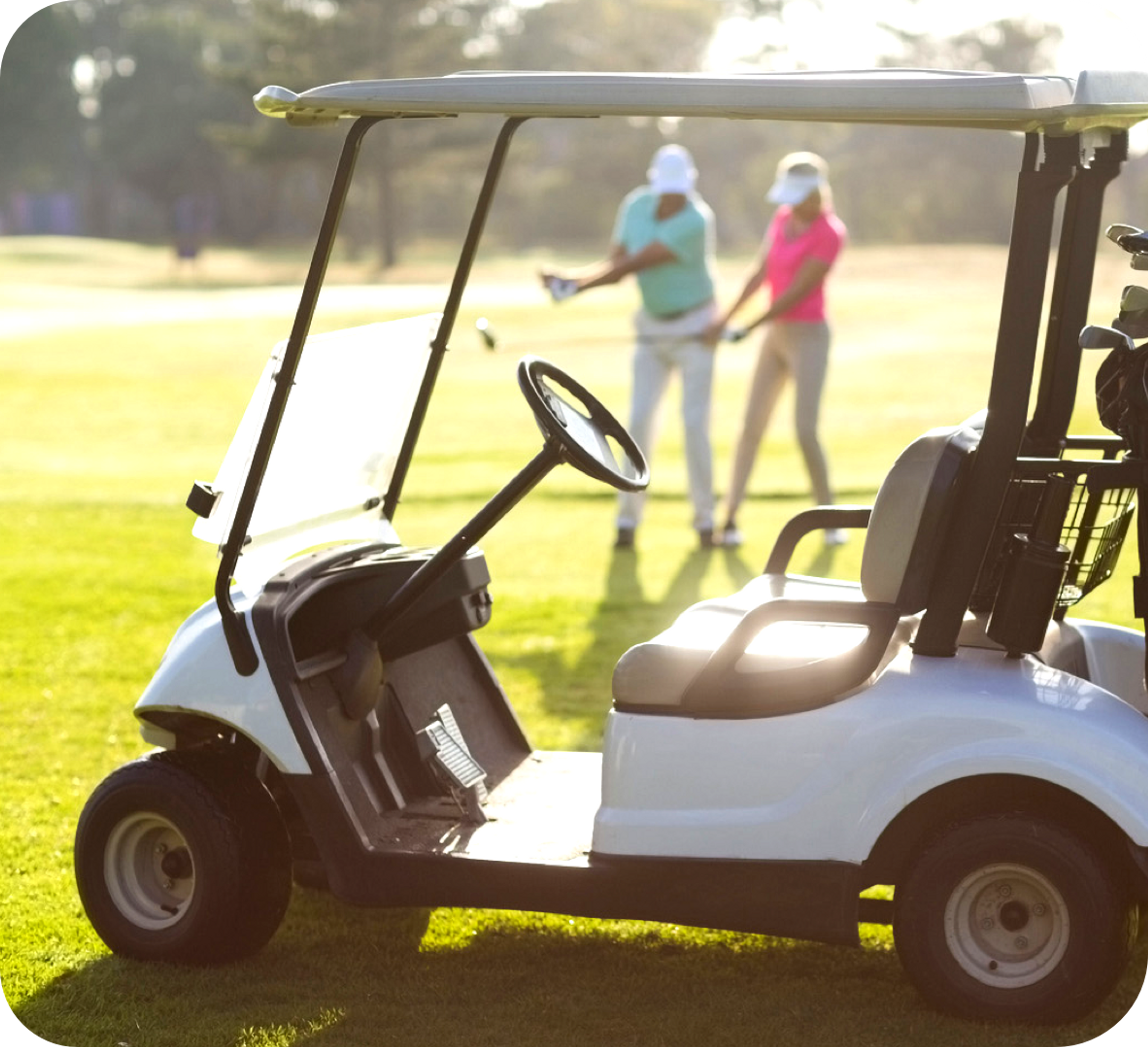 Picture of a white golf cart with a female and male golfer in the image background