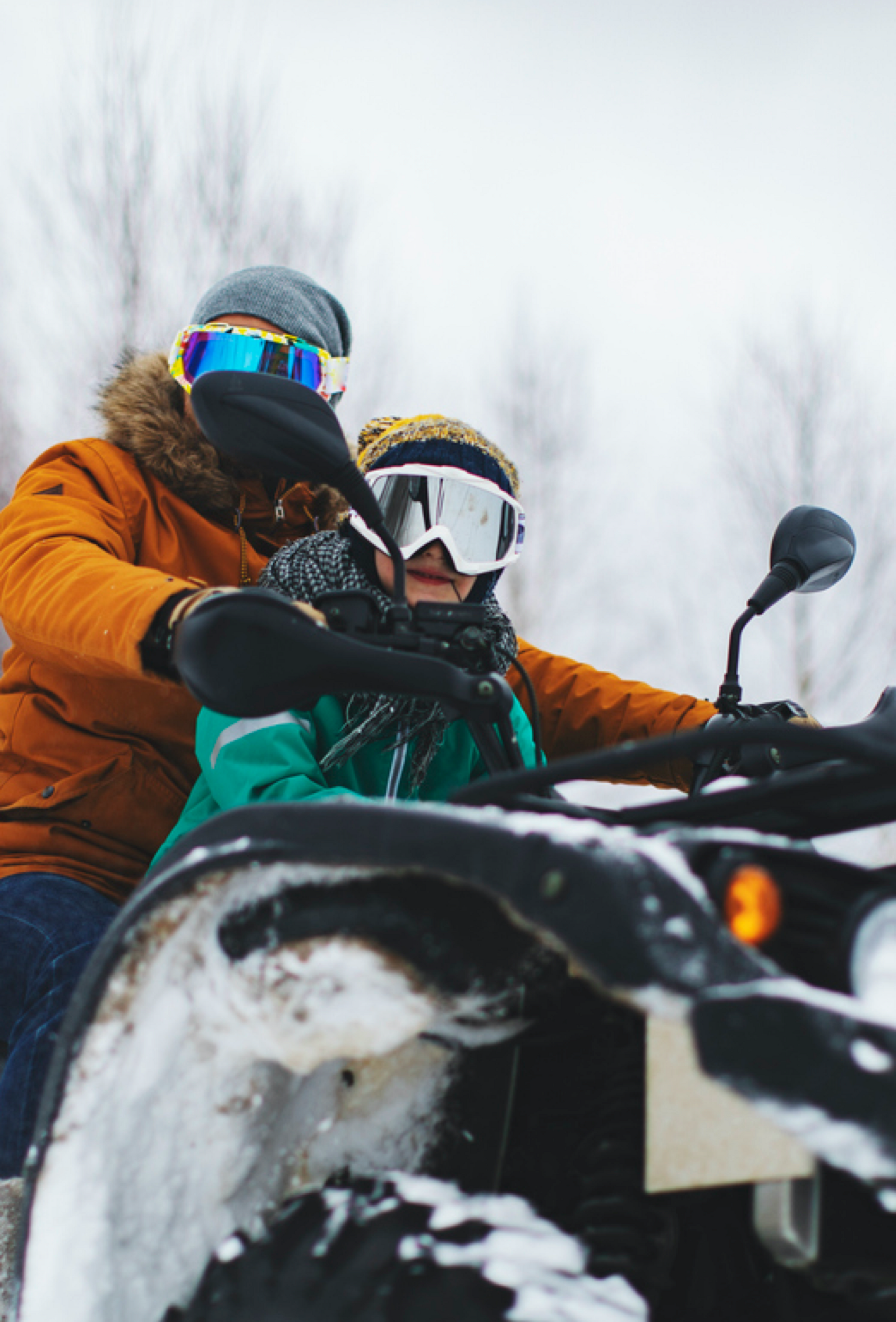 Picture of man and boy riding a snow vehicle