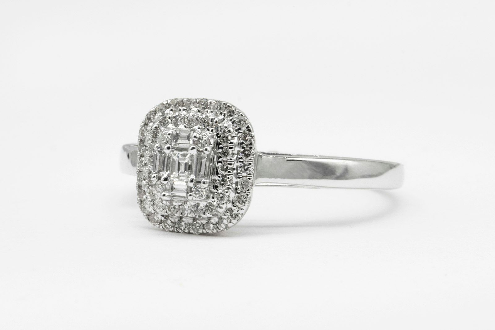 An emerald-cut diamond halo ring