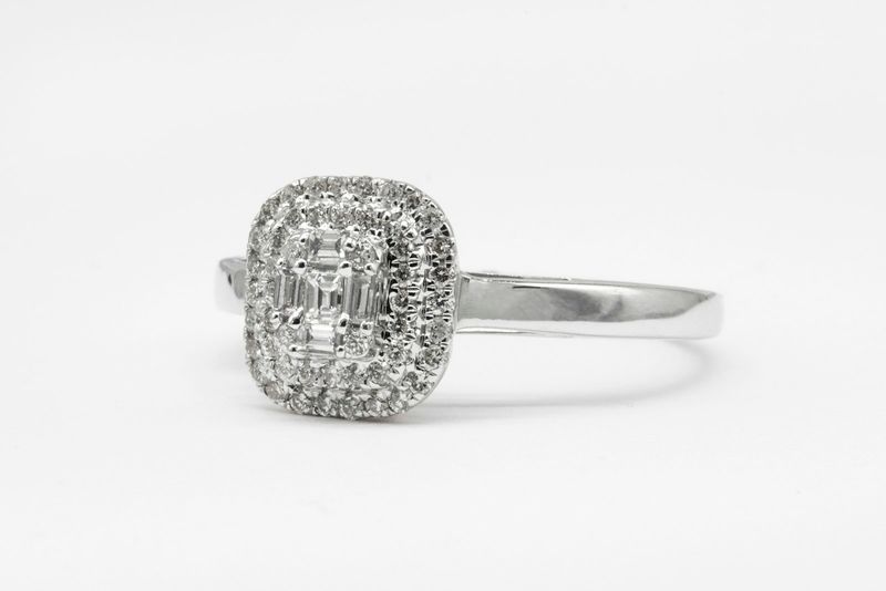 An emerald-cut diamond halo ring