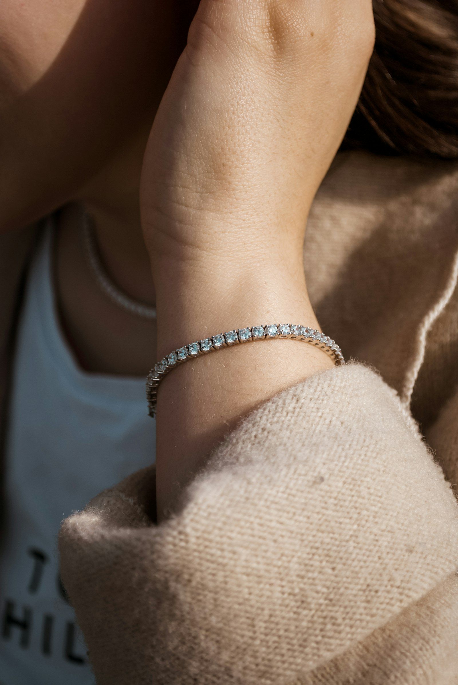A diamond tennis bracelet on a wrist