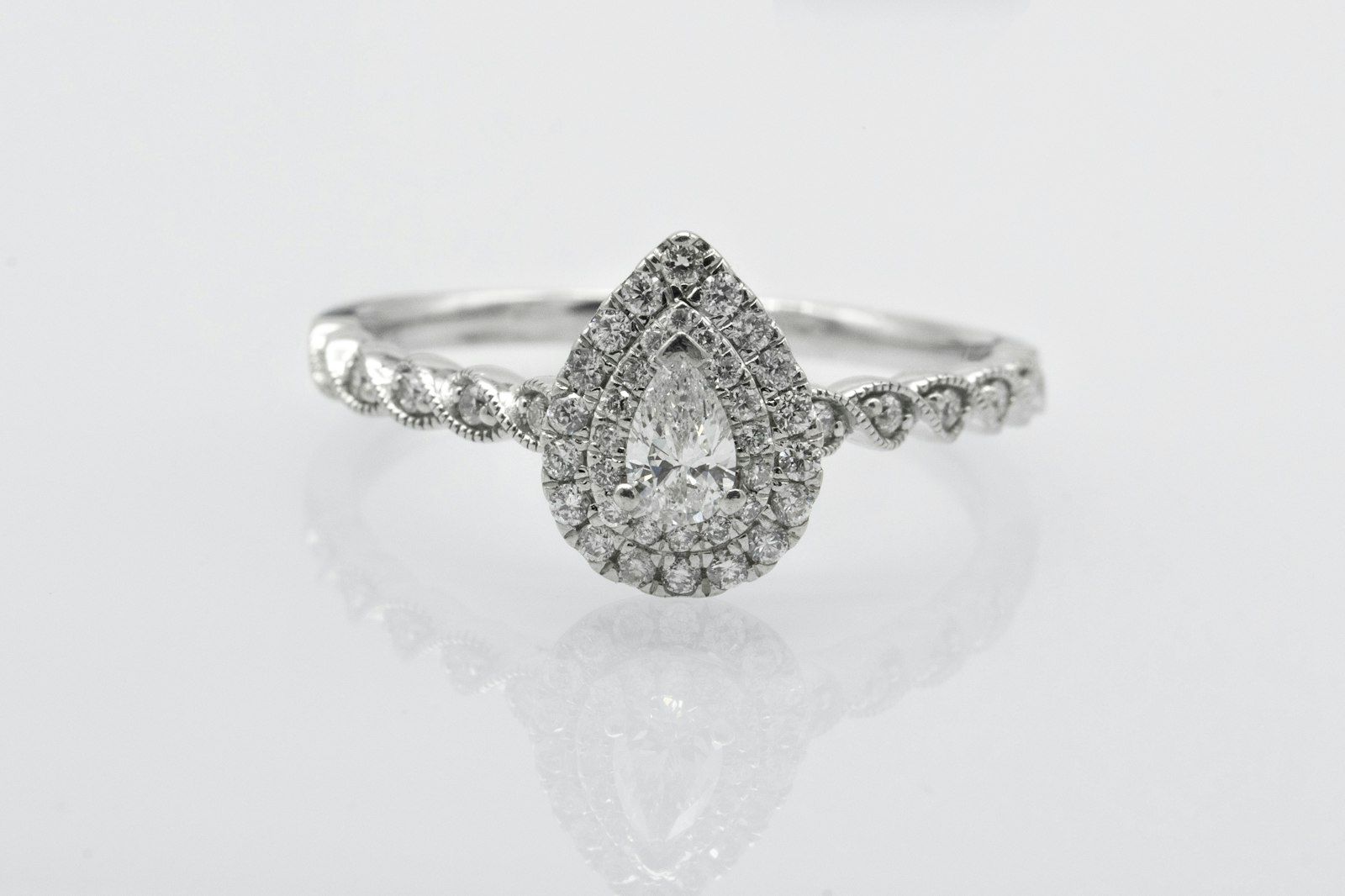 A pear-shaped diamond halo ring