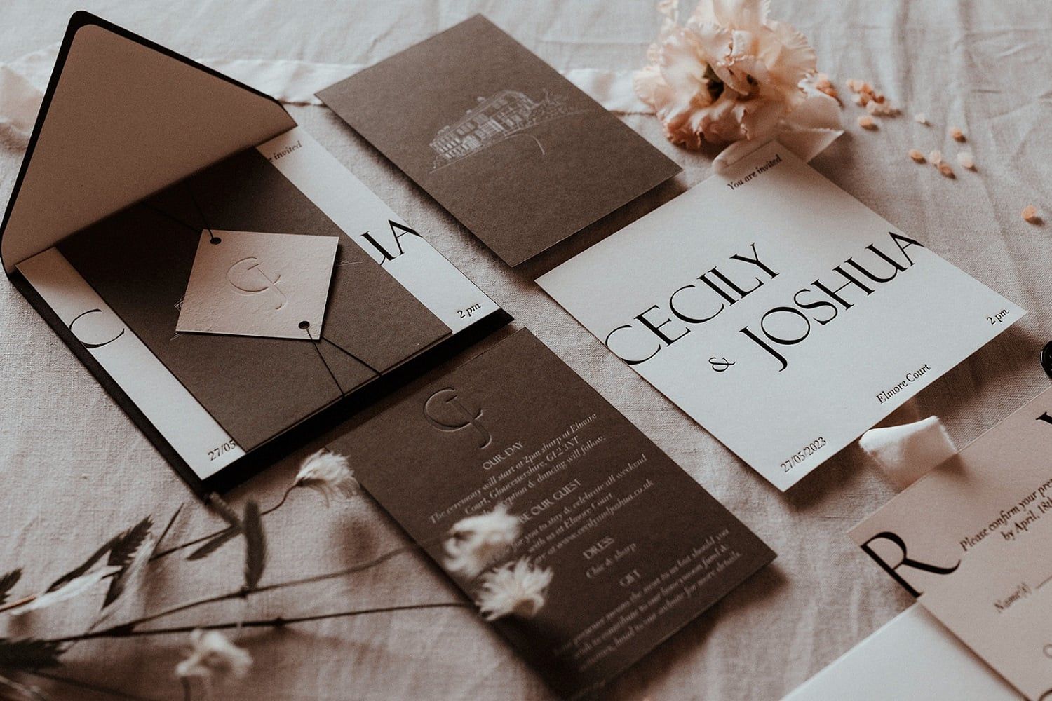 A sophisticated stationery suite on dark stock and white card, featuring a mix of modern serif and