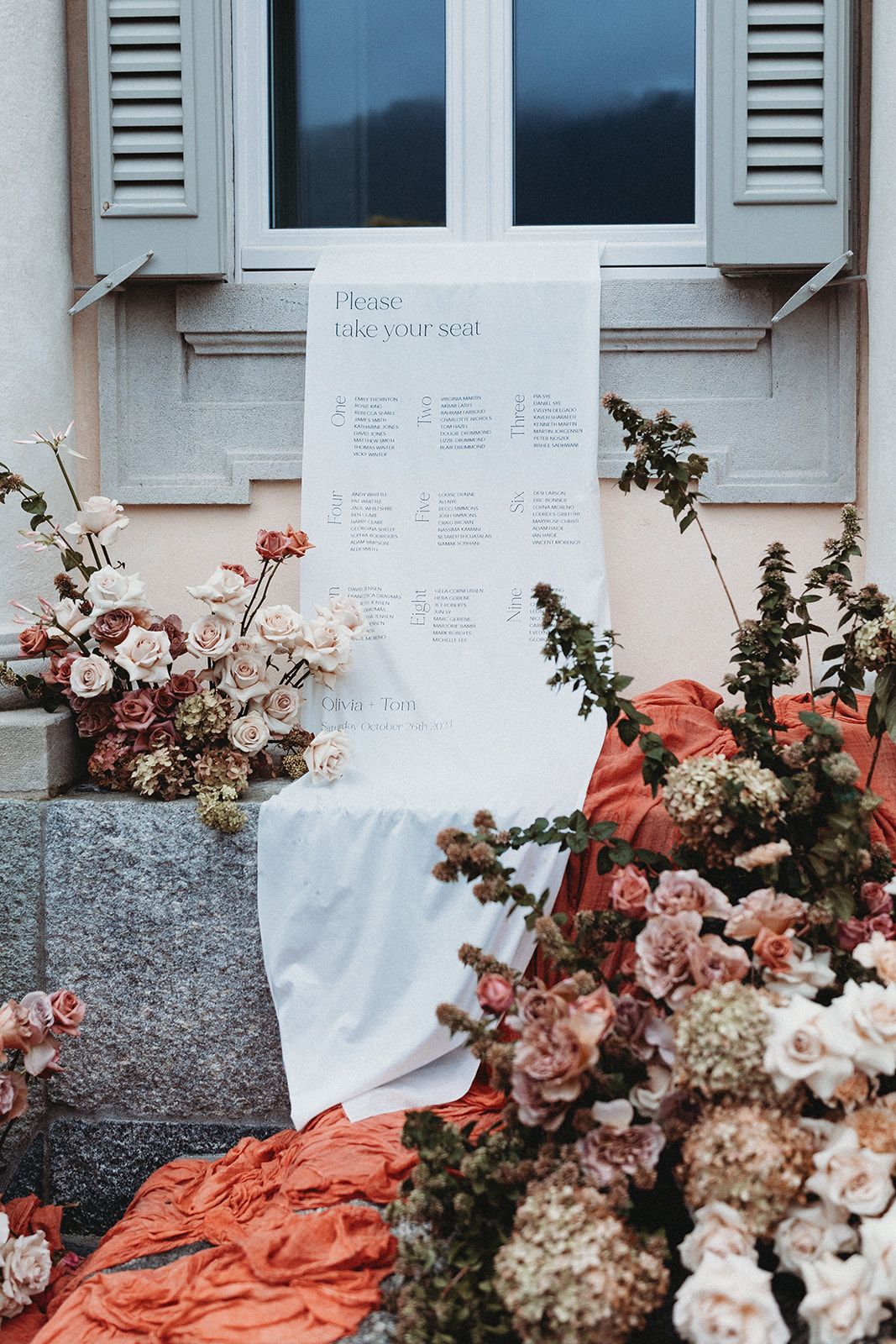 A minimalist and clean wedding table plan in a signage display, featuring a white background with