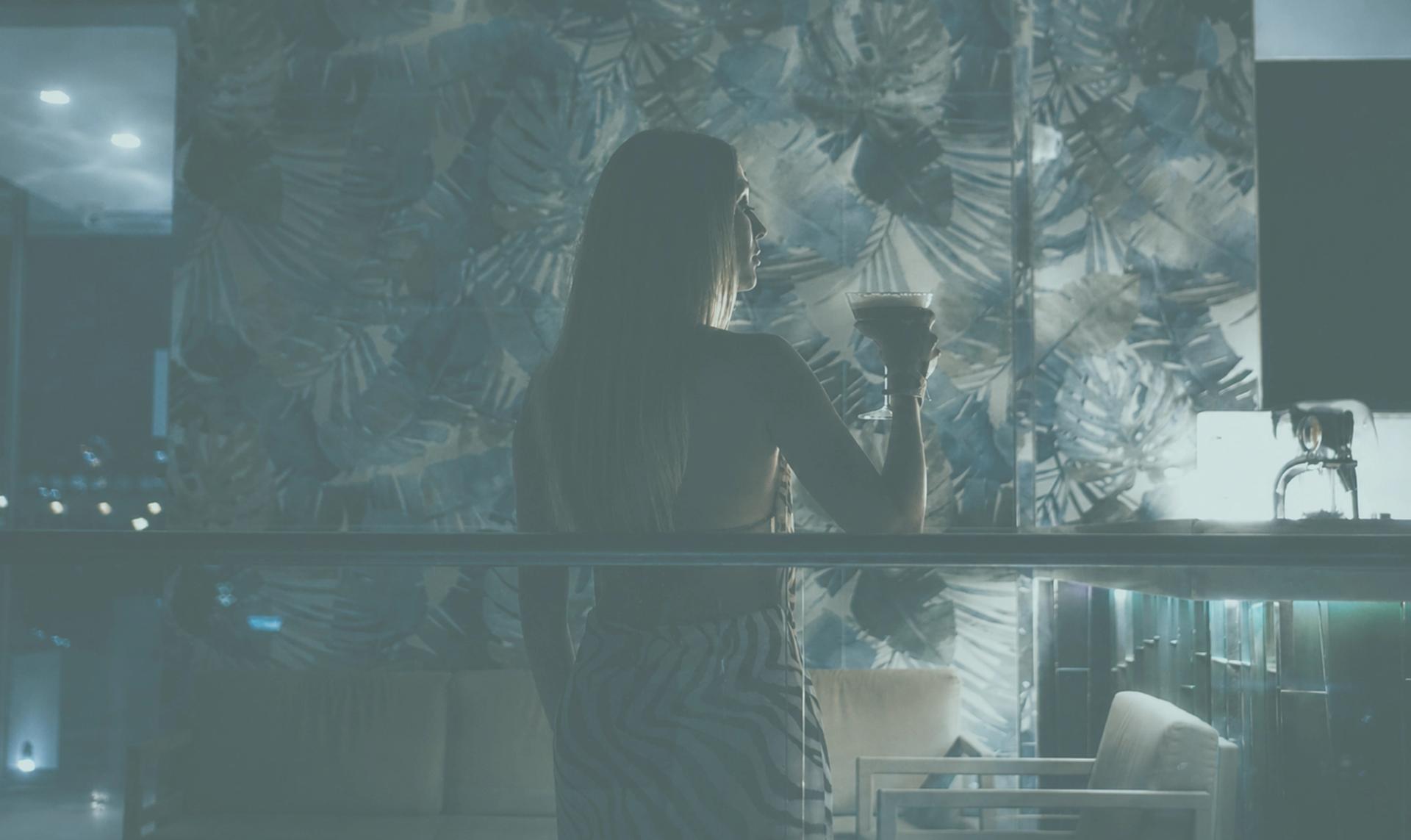 Rooftop lounge at dusk with botanical backdrop