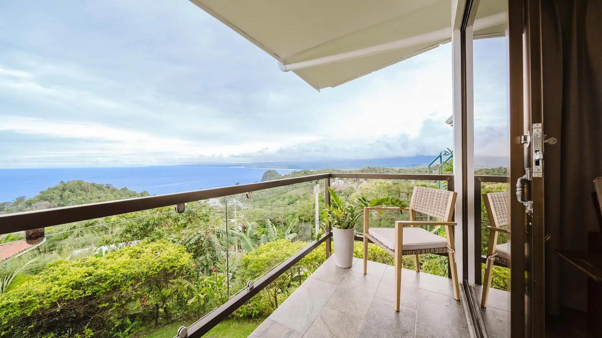 Private balcony at Casa Grande Vista with chairs overlooking jungle and Pacific