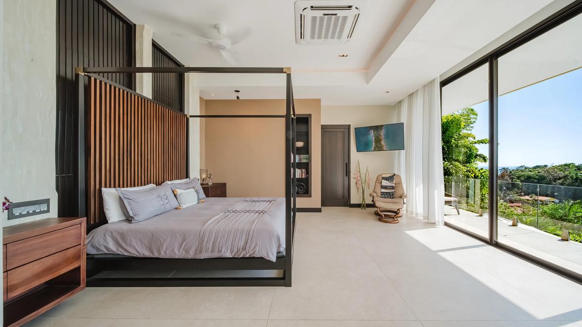 Four poster bed in a Casa Nola bedroom opening to a private terrace
