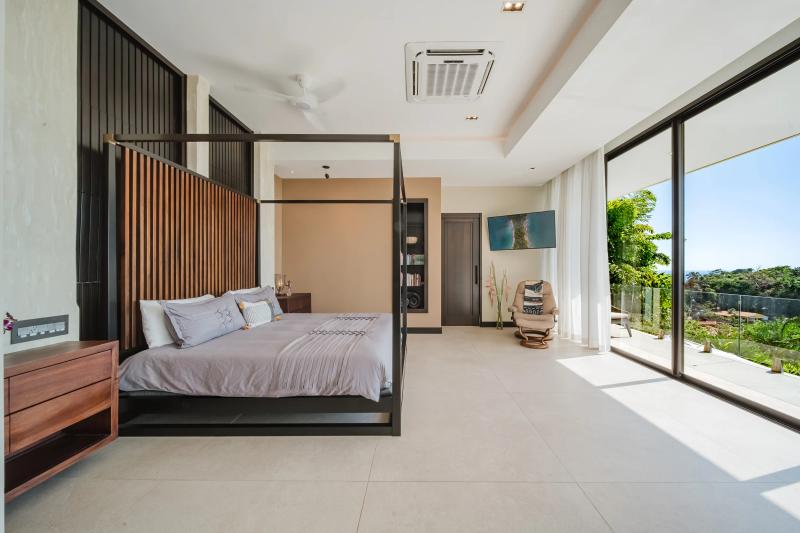 Four poster bed in a Casa Nola bedroom opening to a private terrace