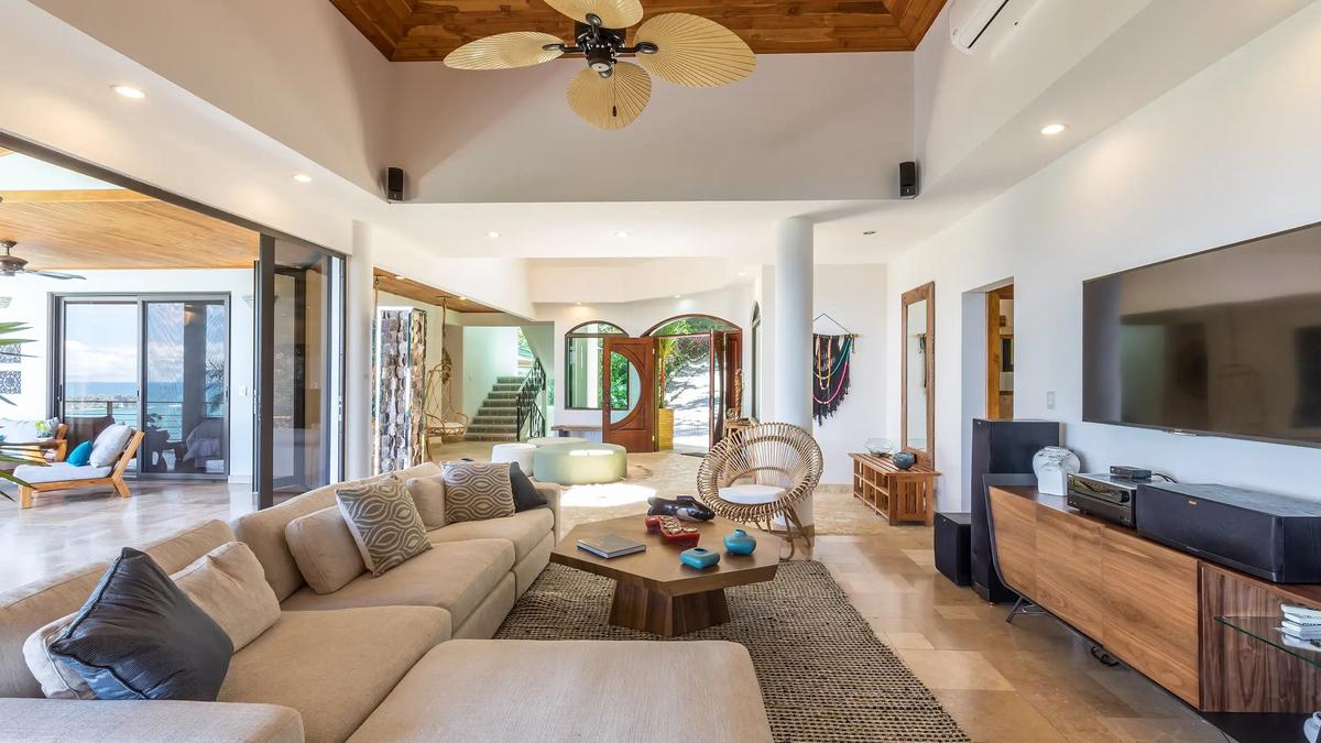 Casa Anjali's living area with TV wall looking toward the entry stairs