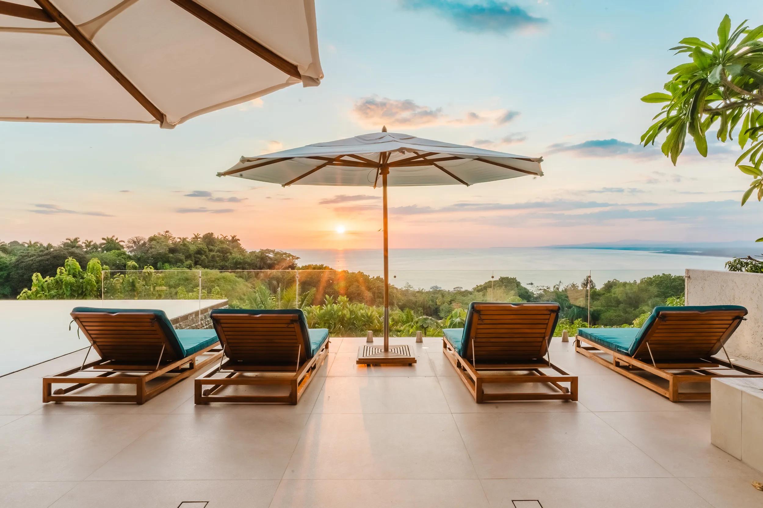 Sun loungers in a row on the Casa Nola terrace at sunset