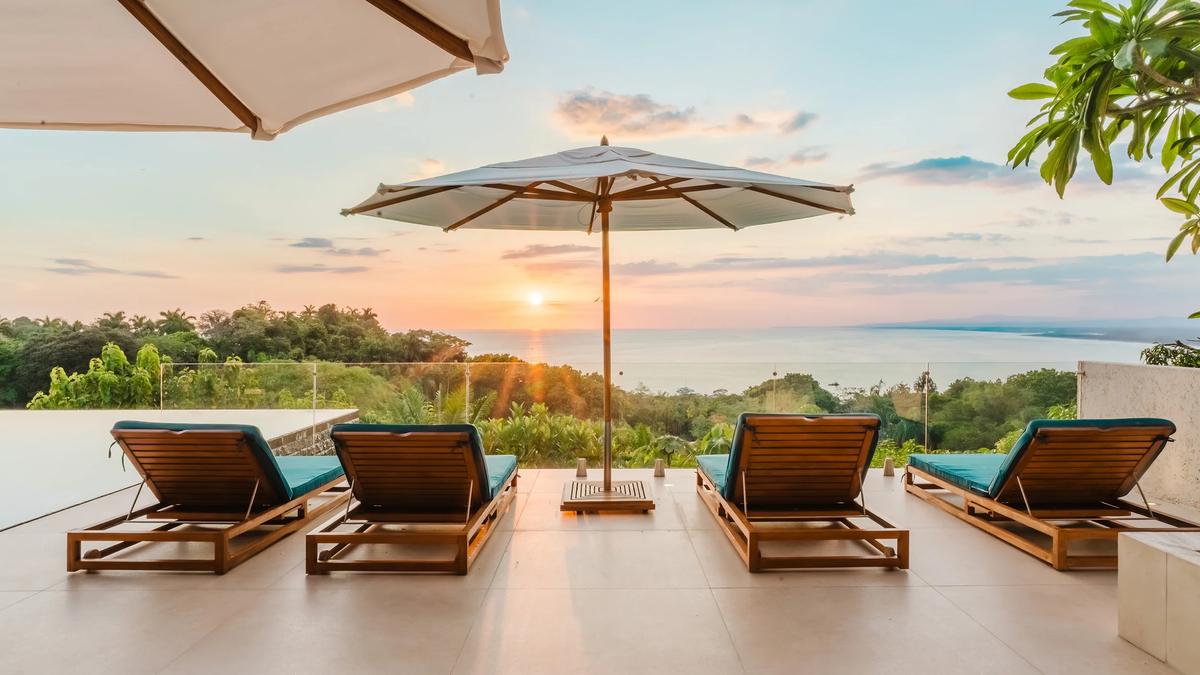 Sun loungers in a row on the Casa Nola terrace at sunset