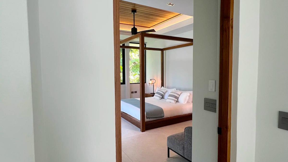 Doorway view into a canopy bed bedroom at Villa de Grace