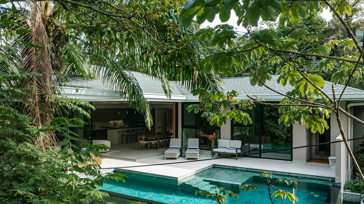Casa Blue Marlin seen through the jungle canopy with pool and open kitchen