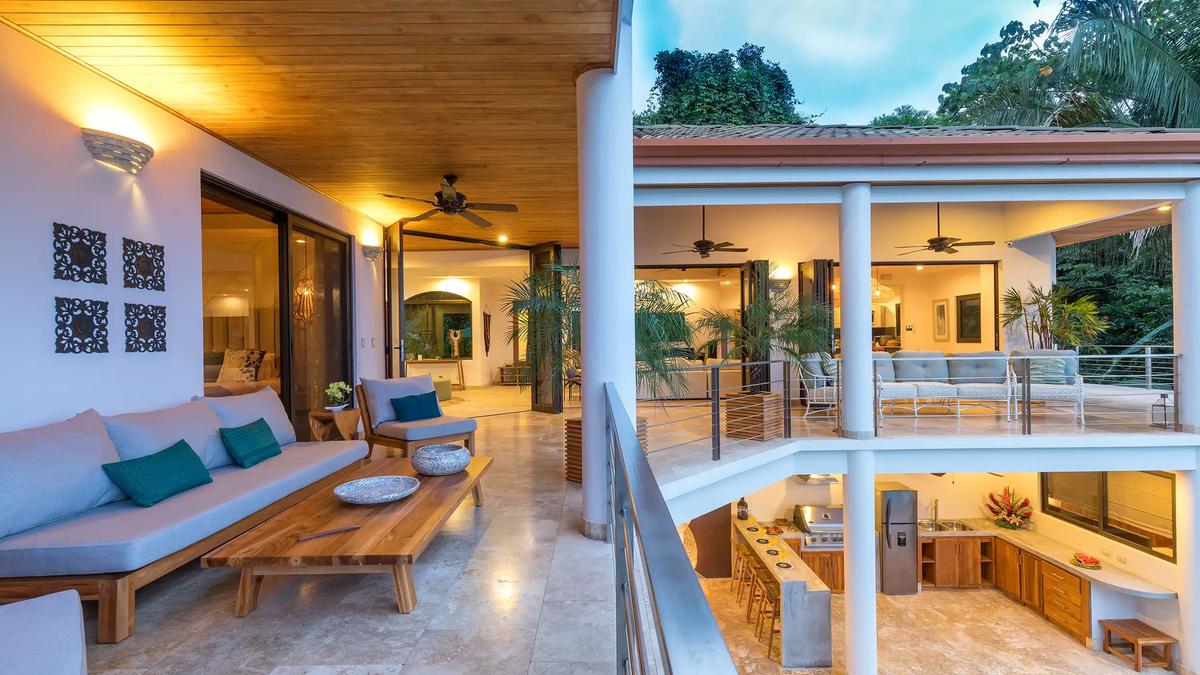 Covered balcony lounge at Casa Anjali overlooking the outdoor kitchen below