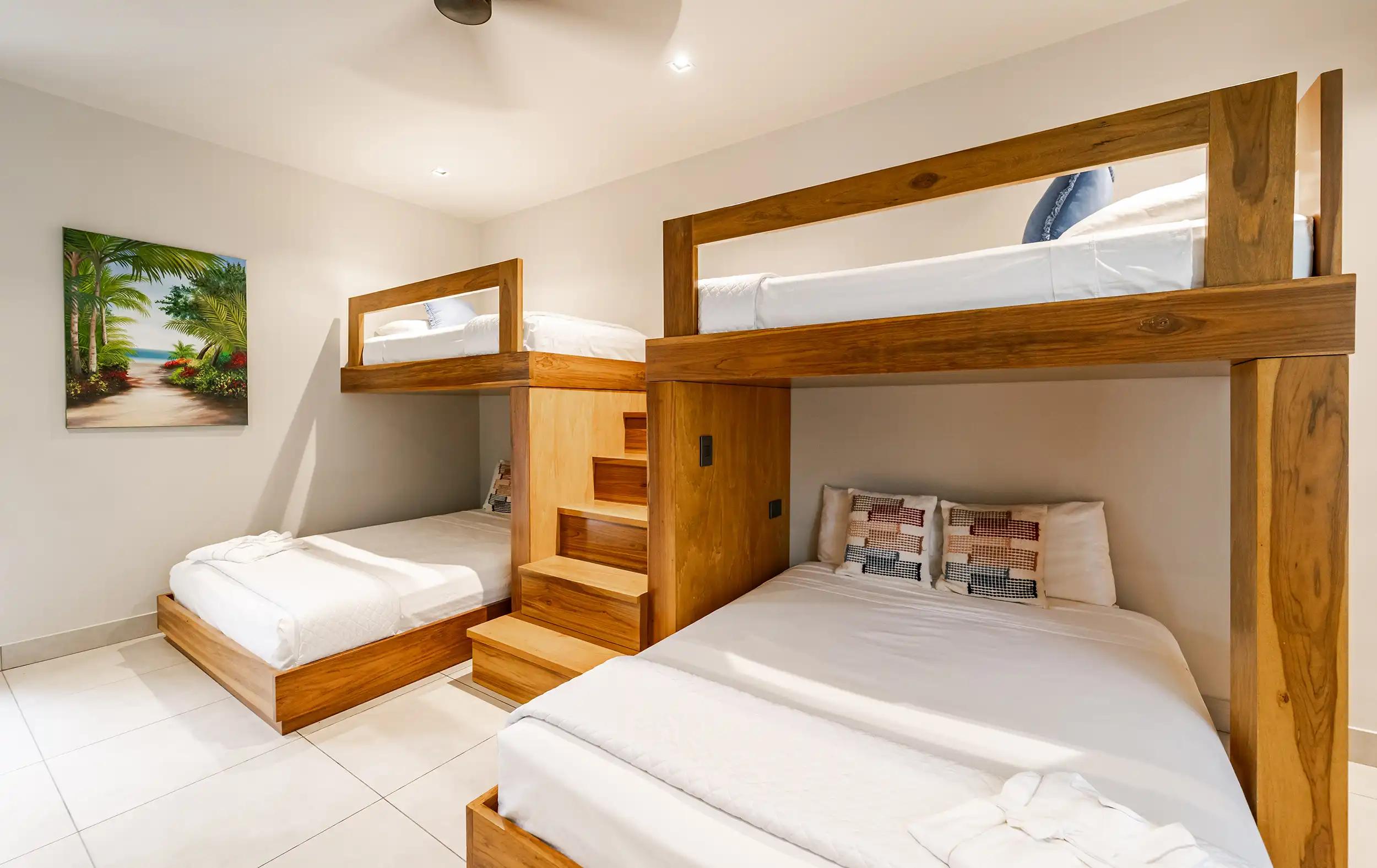 Bunk room at Casa Blue Marlin with built-in teak beds and wooden stairs