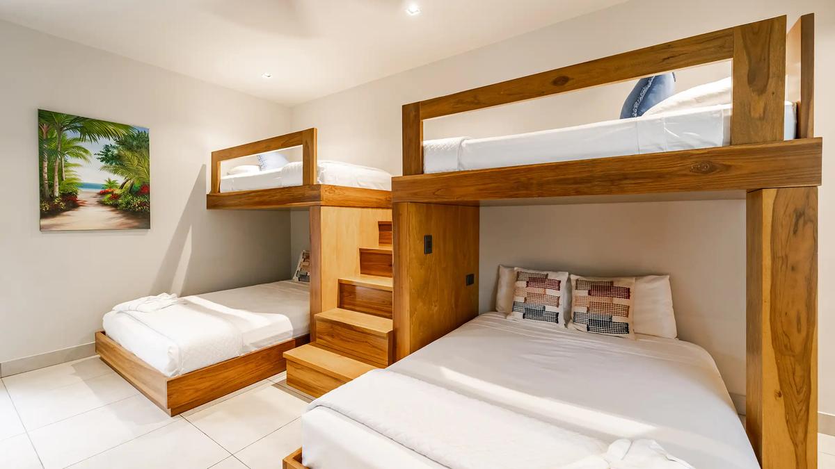 Bunk room at Casa Blue Marlin with built-in teak beds and wooden stairs