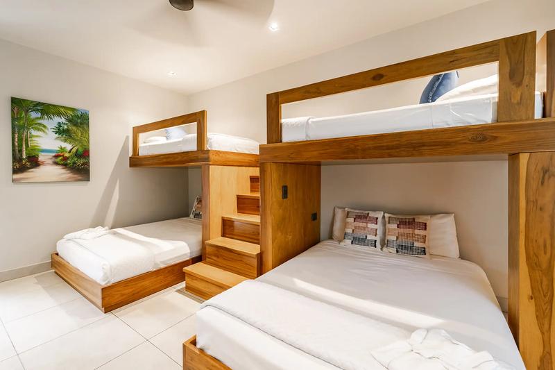Bunk room at Casa Blue Marlin with built-in teak beds and wooden stairs
