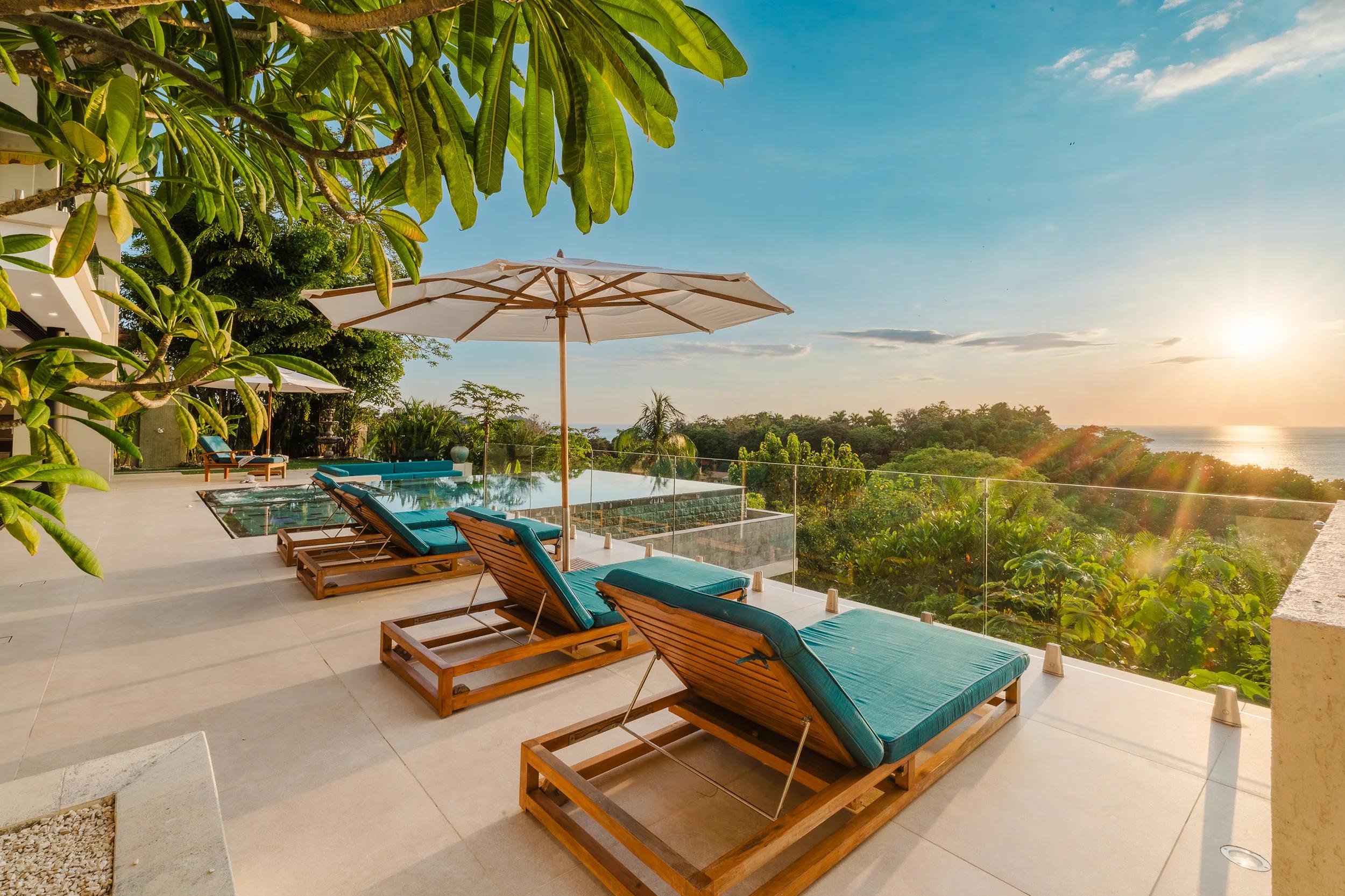 Sunset over the Pacific from Casa Nola's pool terrace, loungers in the last light
