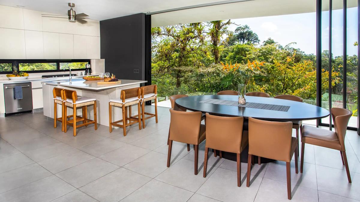 Casa Nueva Vida kitchen and dining area opening wide to the surrounding rainforest