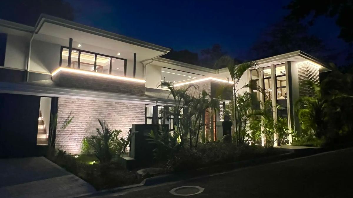 Night view of Villa de Grace with accent lighting along the rooflines