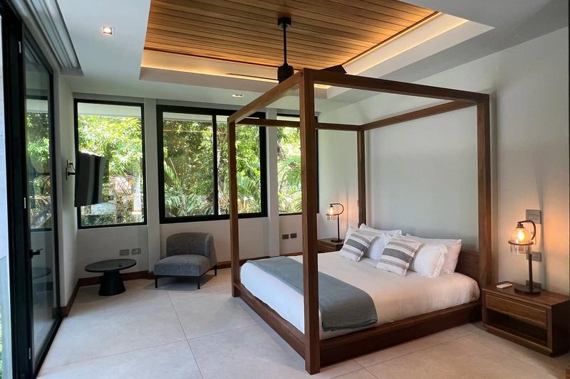 Four poster canopy bed and sitting corner in a Villa de Grace bedroom