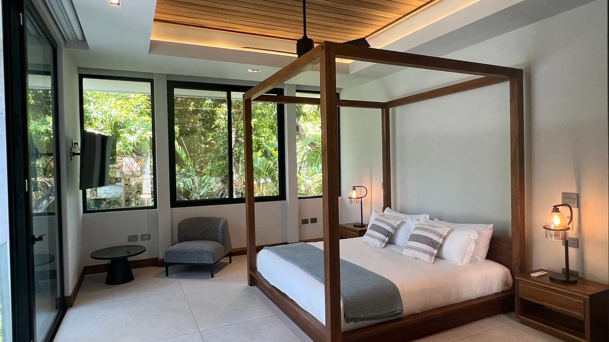 Four poster canopy bed and sitting corner in a Villa de Grace bedroom